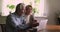 Happy married elderly couple using laptop sit at table indoor