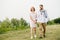 Happy married middle age couple walking through a park hand by hand