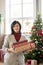 Happy mature brunette woman in casualwear holding giftboxes with presents