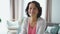 Happy mature businesswoman is posing for portrait sitting in apartment room.