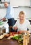 Happy mature couple cooking healthy food