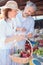 Happy mature couple shopping for groceries in a local organic marketplace