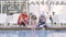 Happy mature couple and their little granddaughter sitting on the edge of the pool. Grandmother, grandfather, and