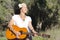 Happy mature hippie woman with guitar