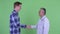 Happy mature Japanese man doctor with young man shaking hands together