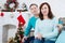 Happy mature,middle aged couple sitting on sofa at home. Christmas celebration, new year holidays