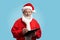 Happy mature Santa Claus holding pen and black clipboard