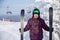 Happy mature skier senior man in activewear and helmet with ski background mountain lift