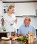 Happy mature woman and elderly senior cooking