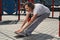 Happy mature woman exercising on sports ground