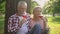 Happy mature woman and man drinking wine and enjoying romantic date in park