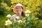 Happy mature woman in roses plant