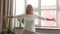 Happy mature woman standing with arms outstretched, enjoying life