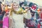 Happy mature woman in tinsel with Christmas toys at fair