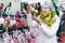 Happy mature woman in tinsel with Christmas toys at fair