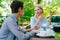 Happy mature women chatting in outdoor cafe relaxing at table enjoying company