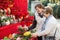 Happy mature women selecting floral compositions