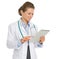 Happy medical doctor woman using tablet PC