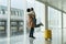 Happy meeting at airport: african man met and embrace woman after arrival in empty modern terminal