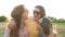 Happy Meeting of Three Friends Hugging in the Street During Warm Summer Day. Three Girls Wearing Sunglasses and Short