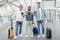 Happy Men Travelers Posing With Luggage Showing Passports In Airport