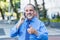 Happy mexican senior businessman at phone showing thumb up