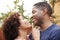 Happy middle aged African American  couple embracing outdoors, side view,close up