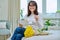 Happy middle aged female with bouquet of flowers, at home