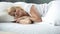 Happy middle-aged female sleeping in bed on orthopedic mattress, healthy rest