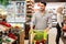 Happy Middle Eastern Guy Doing Grocery Shopping In Modern Supermarket