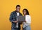 Happy millennial african american couple looking at laptop and choosing purchase or watch lesson or video