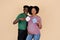 Happy millennial african american guy and woman with big belly have fun, hold paper with inscription boy, girl