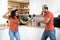 Happy millennial african american woman and man have fun, fighting with imaginary swords