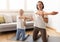 Happy millennial caucasian woman in sportswear and teenage daughter practice yoga, doing hand stretching