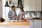 Happy millennial couple in love preparing food at modern kitchen