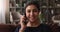 Happy millennial indian woman holding cellphone conversation.
