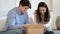 Happy millennial spouses opening cardboard box received by delivery service