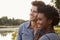 Happy mixed race couple admiring a view in the countryside