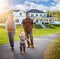 Happy Mixed Race Family Walking in Front of Beautiful Custom Home