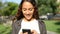 Happy mixed race woman using smart phone