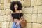 Happy mixed woman with afro hair laughing outdoors