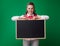 Happy modern student woman in headphones showing blackboard