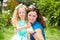 Happy mom and child girl hugging in outdoor. The concept of childhood and family. Portrait parent mother and kid. Positive human e