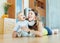 Happy mom with child on wooden floor