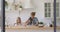 Happy mom and funny small daughters preparing dough in kitchen