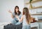 Happy mom and little daughter playing in the bedroom, doing yoga, morning routine