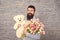 Happy moments. Love date. happy international holiday. happy bearded man with tulip bouquet and bear. Flower for March 8