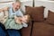 Happy moments. Portrait of cheerful grandfather and excited grandson embracing and having fun while relaxing on a couch