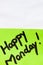 Happy Monday handwriting text close up isolated on green paper with copy space. Writing text on memo post reminder