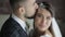 Happy morning for young millennial wedding couple hugging and kissing in the bedroom in the morning, close view. Bearded